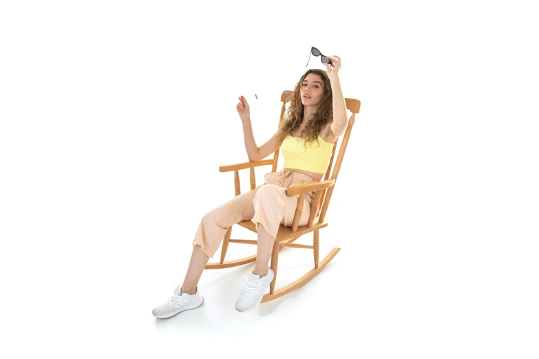 a woman sitting in a rocking chair on a white background