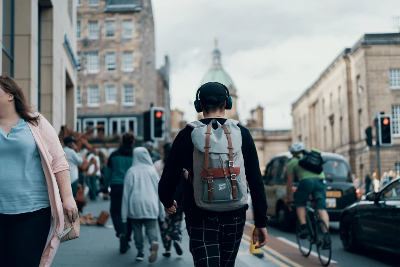 people walking on the sidewalk in an urban city