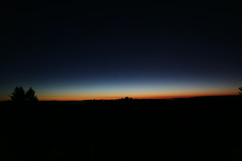 the sunset lights up the sky with clouds