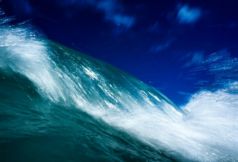 a blue sky over the crest of a surfboard