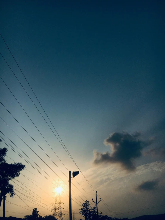 a po taken from the top of the car of the road, with power lines in the sky