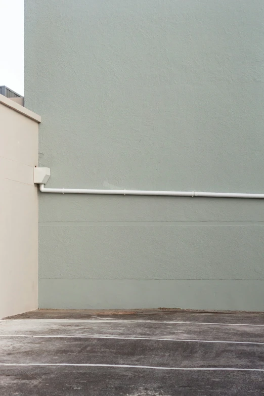 a red fire hydrant by a wall with a white railing