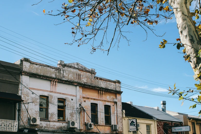 the old, run down building is painted pink