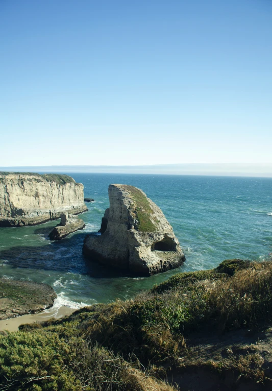 a po of a large rock formation on the edge of the water