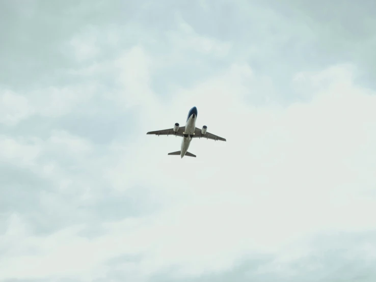 an airplane in flight in the clouds on a cloudy day