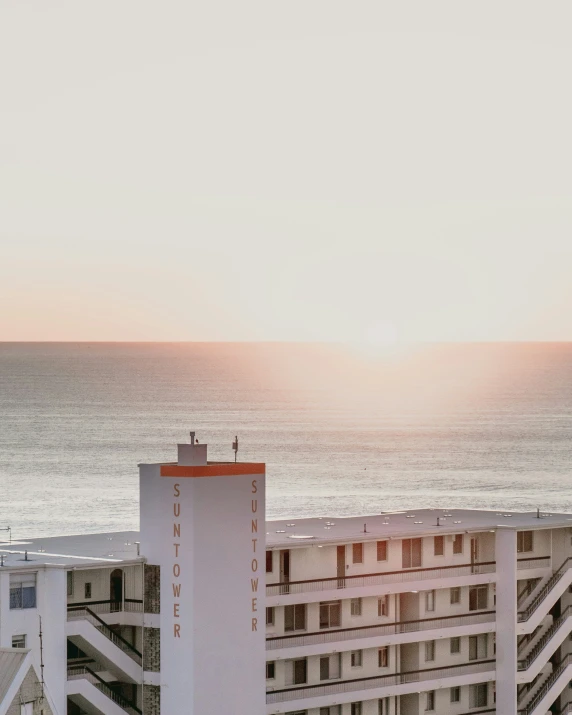 the city with large building next to it is overlooking the ocean