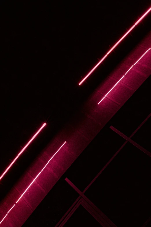 a close up of lines on a wall and a black background