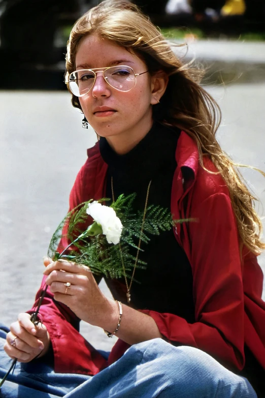 a woman holding a bouquet of white flowers