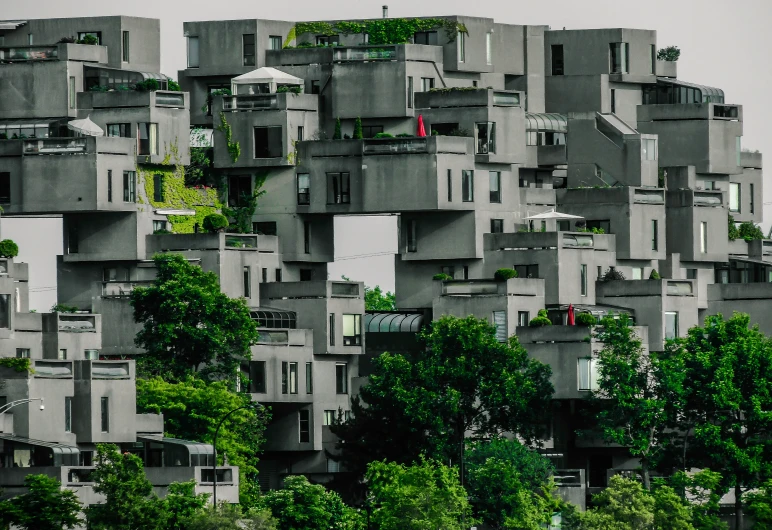 large, open - air buildings are all stacked with greenery growing on them