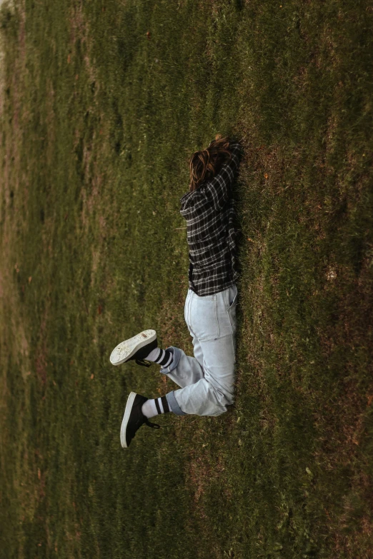 a person is laying down on the grass