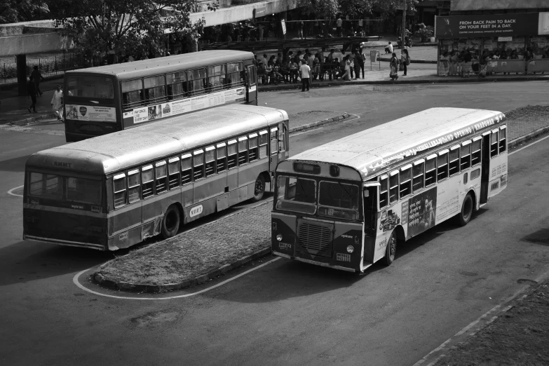 two public buses parked in a parking lot