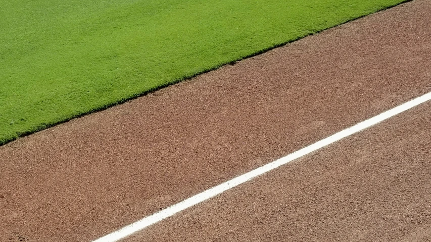 a baseball field with a base ball field and two people standing on it