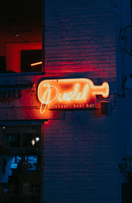 a lit neon sign on the side of a building
