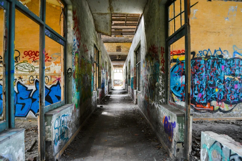 a hallway in an abandoned building covered in graffiti