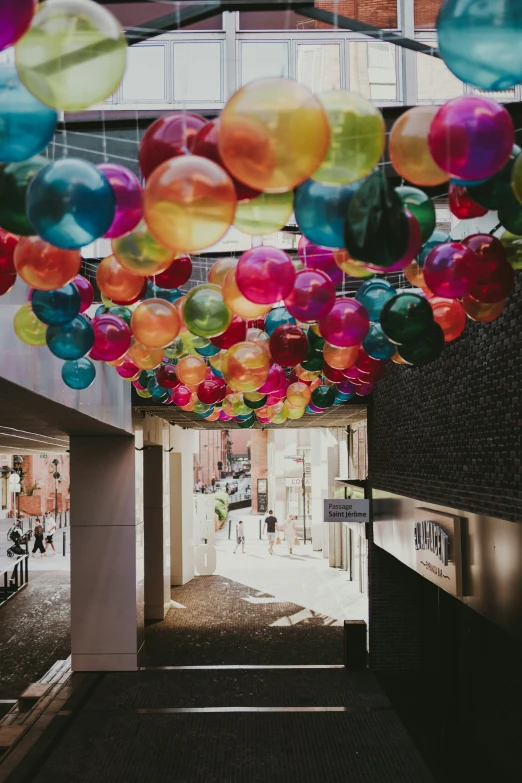 a hallway filled with lots of balloons floating in the air