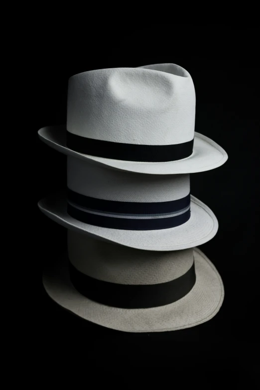 white hats on a black background, taken in a light