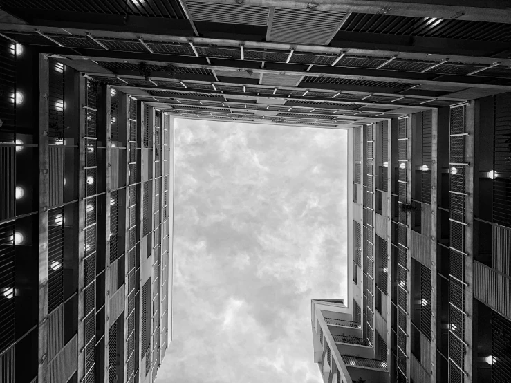 a group of tall buildings that are under a cloudy sky