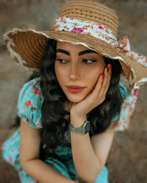 a young woman with a hat and dress sitting on a floor