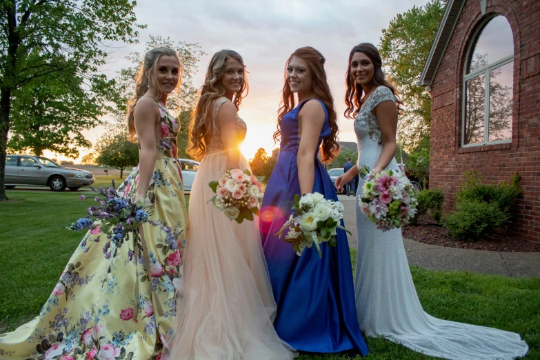 four girls in evening dress posing for a picture