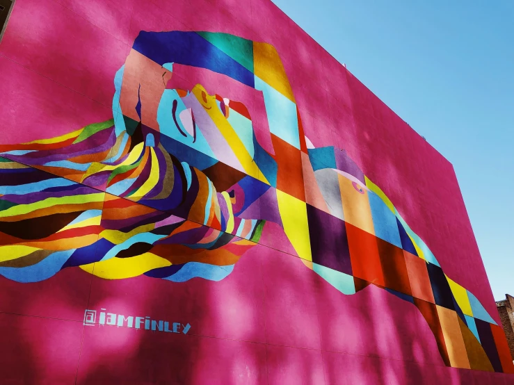 a colorfully designed mural is on the side of a building