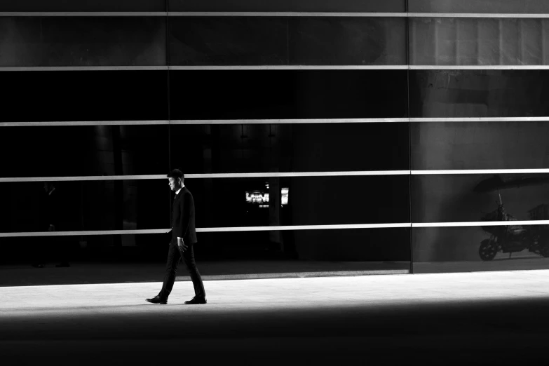 a man is walking in an area of dark