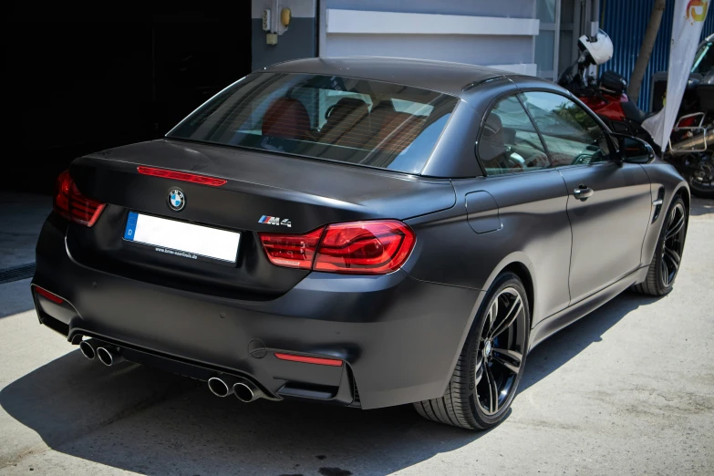 the back of a black bmw car on a city street