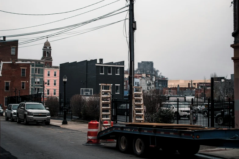 a street with cars, buildings and a fire hydrant