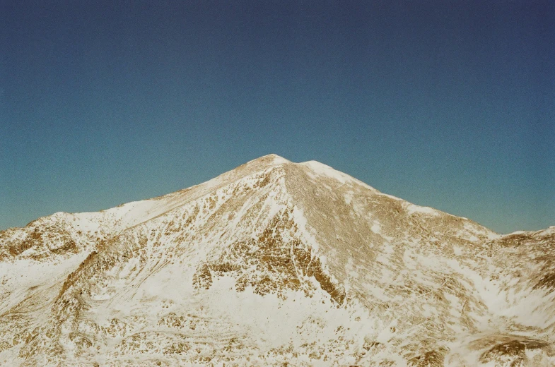 a large mountain covered in snow and cloud