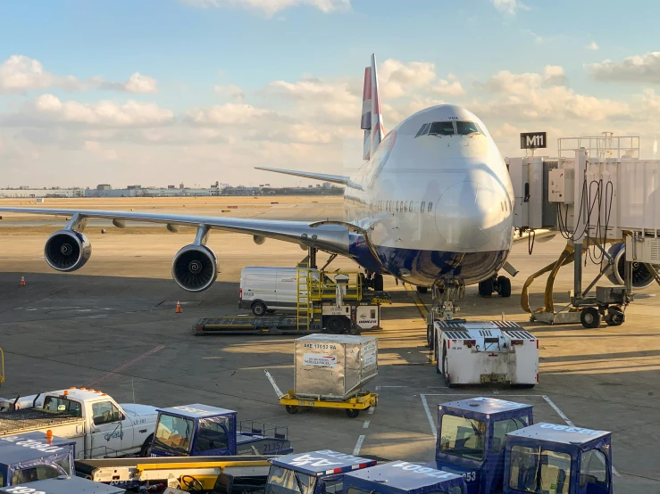 a plane is being unloaded and is parked on the tarmac