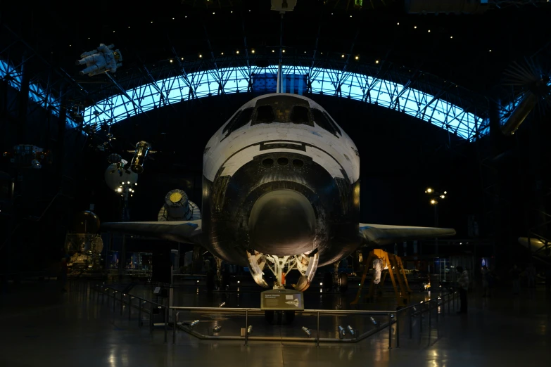 the large plane is being displayed with the people looking on