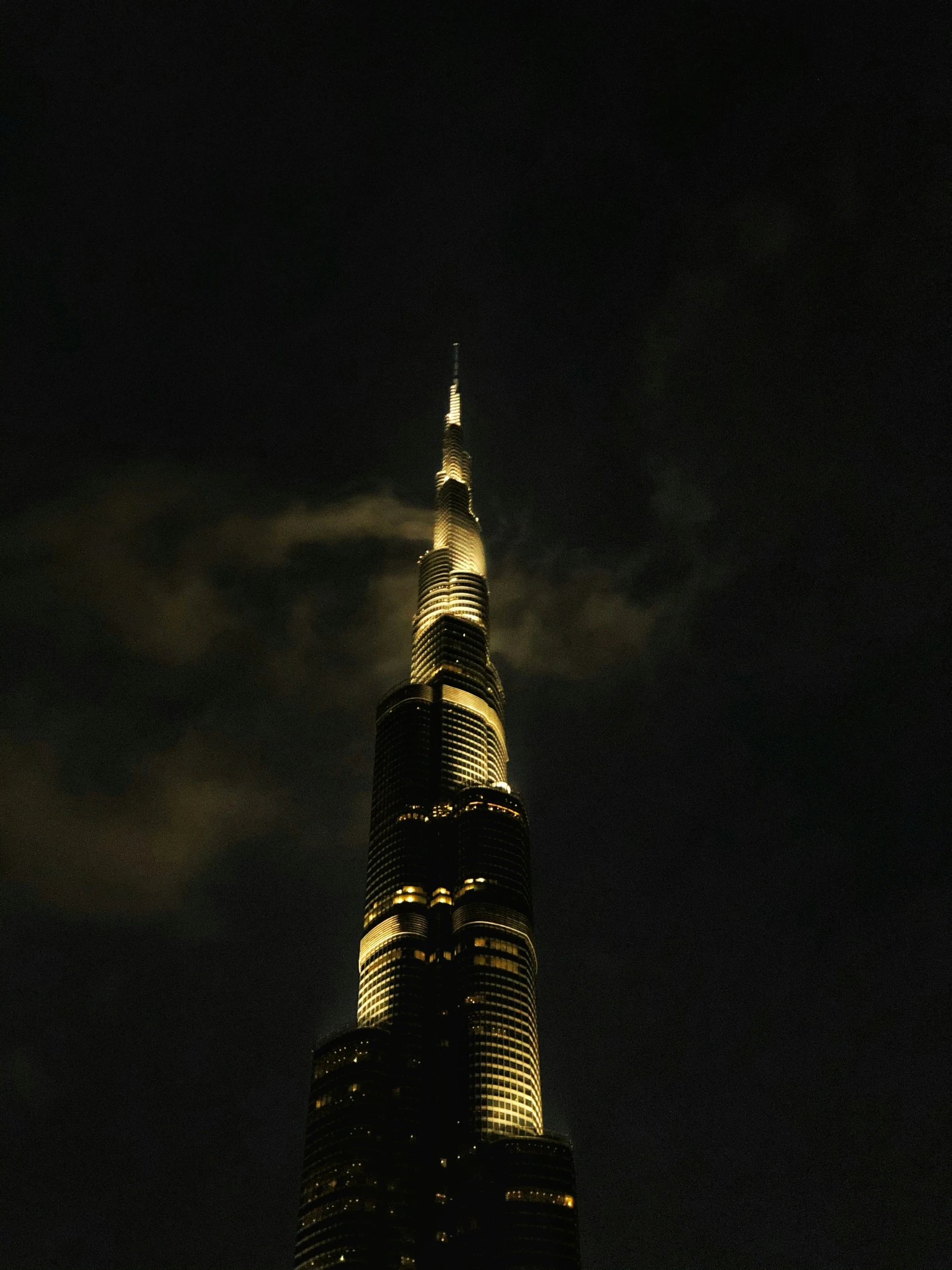 the top of the burj tower lit up at night