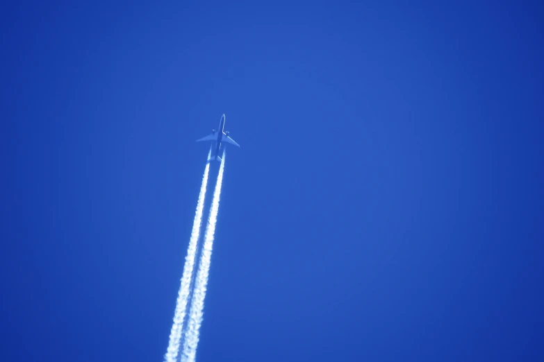 an airplane is flying high into the blue sky