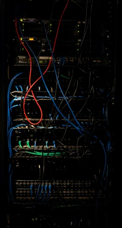 a couple of wires and cables are connected to the backside of a server