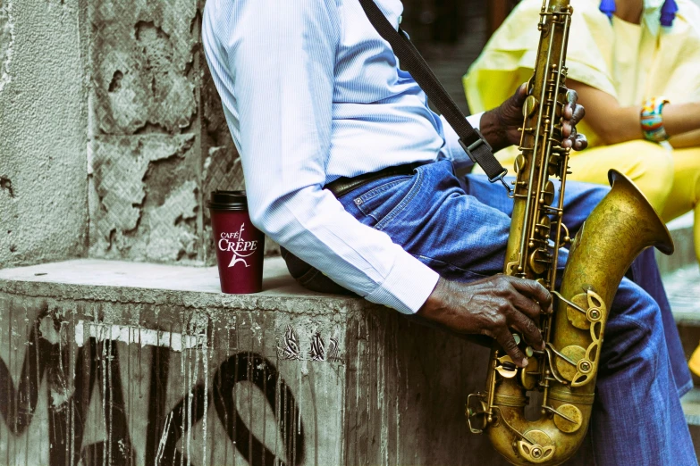 a man plays the saxophone with other musicians on either side