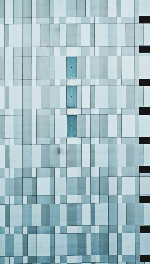 a very unique picture of a modern building made out of square shaped tiles