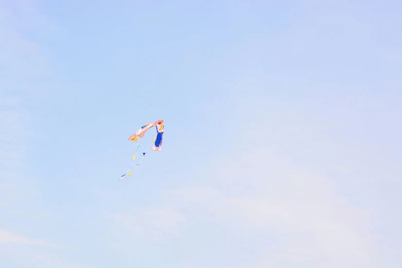 a kite with a blue shirt flying in the air