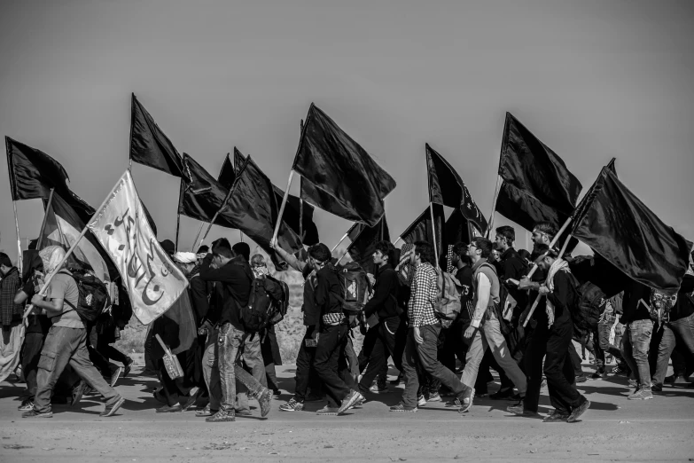 a group of people holding flags walking in a line