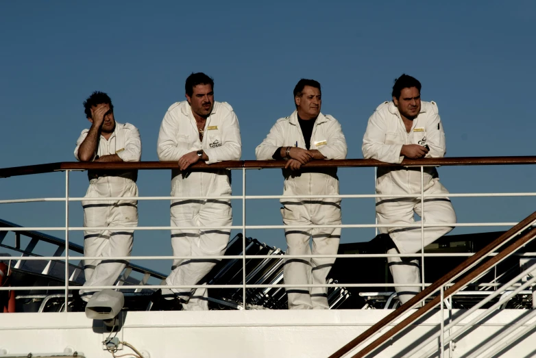 the four men are wearing white on the ship