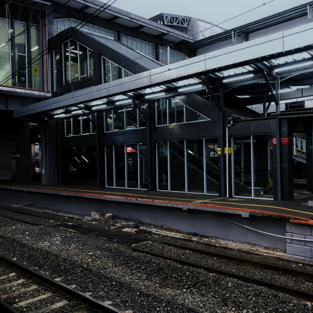 a train at a station is next to some tracks