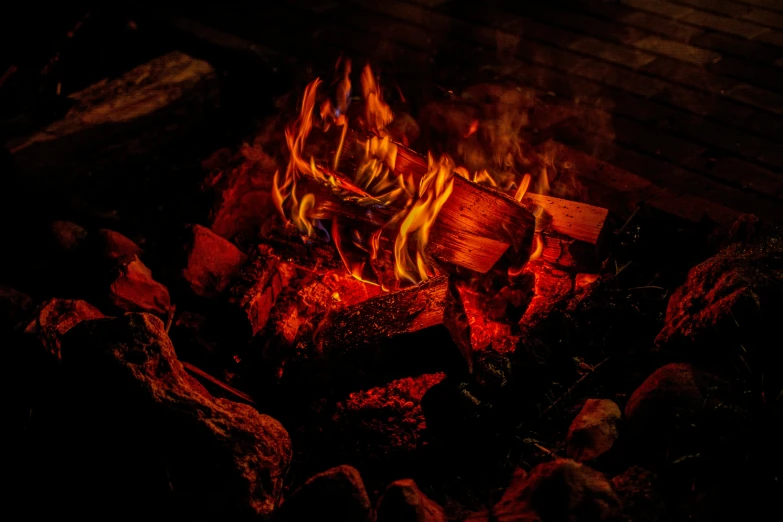 a bunch of wood burning with flames at night