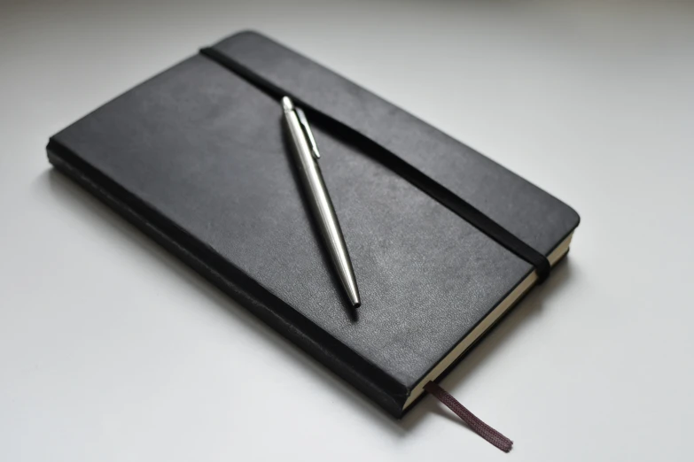 a notepad with a pen is sitting on the desk