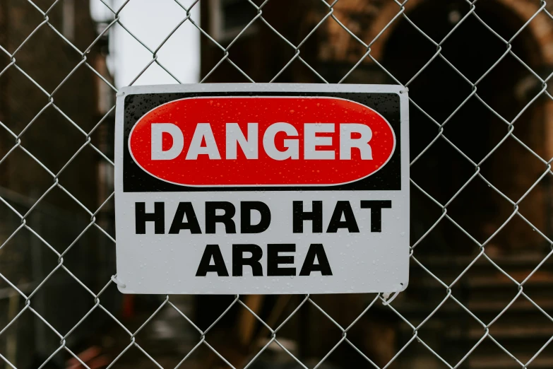 a red and white sign that says danger in black lettering