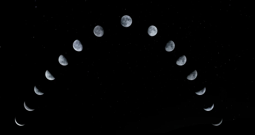 moon phases are shown in an almost black sky