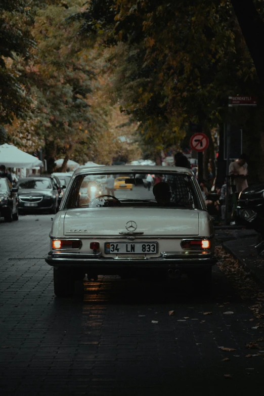 the old car is driving on the wet road