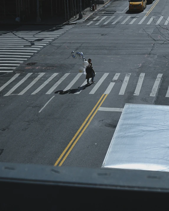 a man standing on the corner of a parking lot