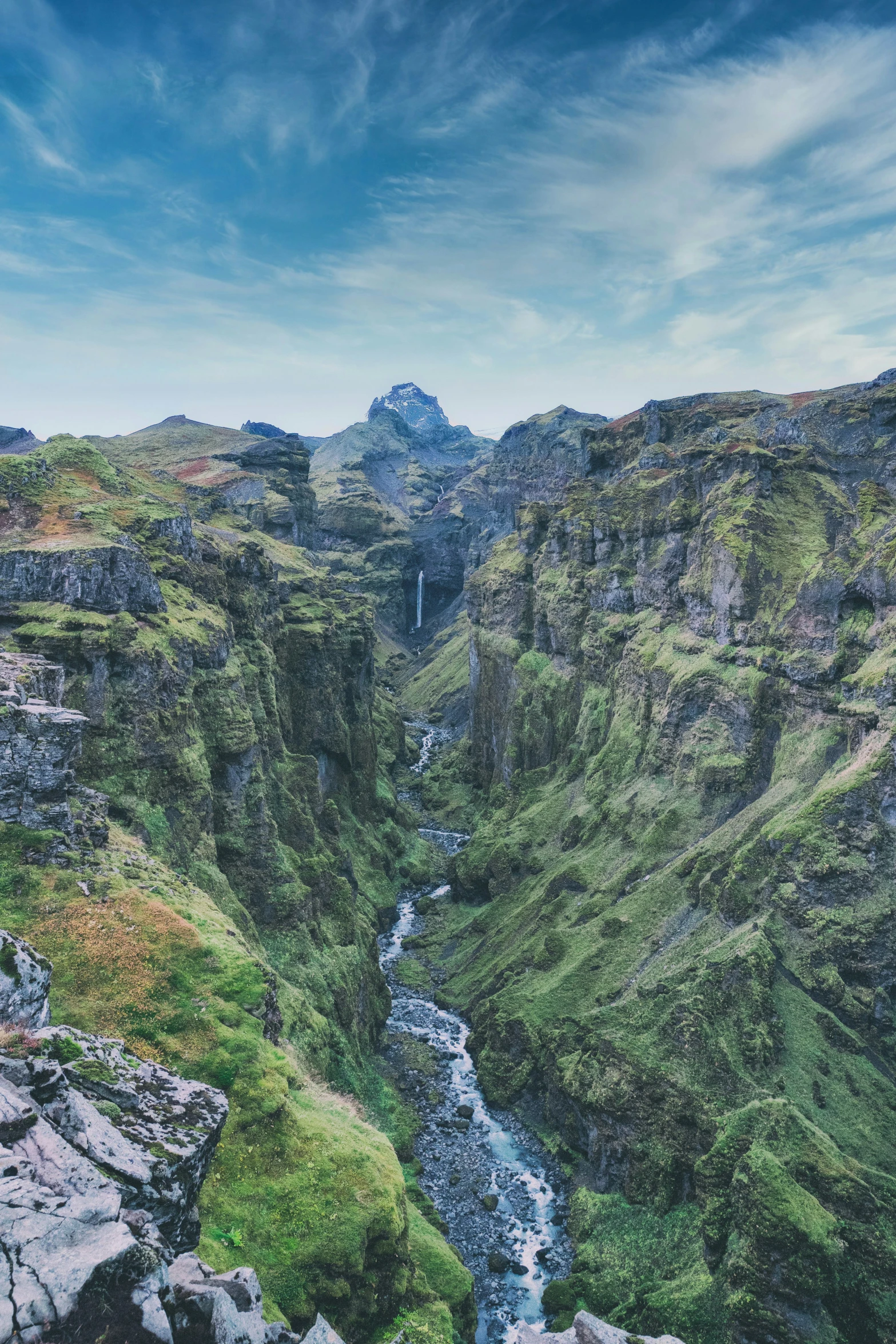 view from above a cliff looking down at a river