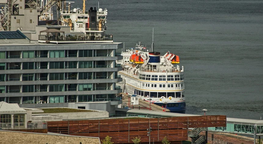 a ship parked in a harbor next to a large building