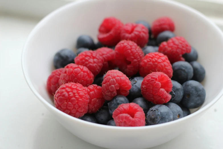 berries in a white bowl with lots of berries