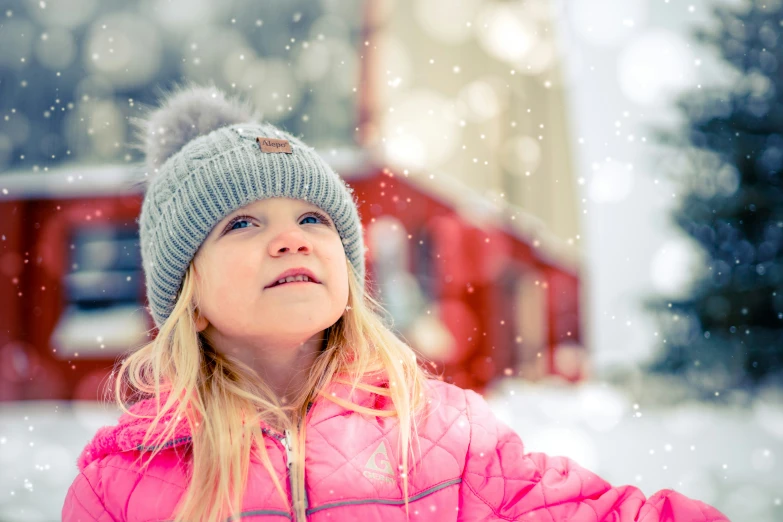 the child is playing with snow on a cold day