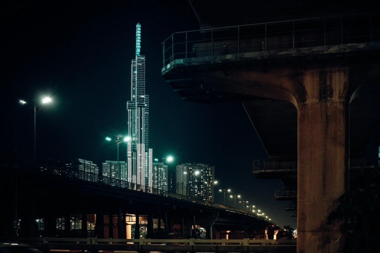 a tall building on the side of a bridge with street lamps in front